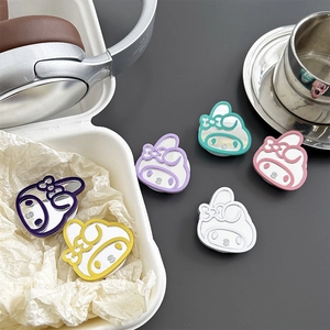 Macro detail of cartoon character mirror phone grip stand in various pastel colors