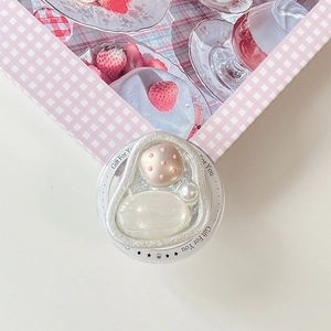 Detail of magnetic phone grip with opal stone and pearl inlay in textured silver frame