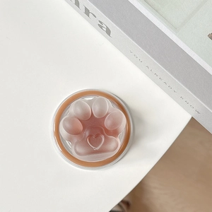 Detailed close-up of a semi-transparent cat paw MagSafe phone socket on a white surface