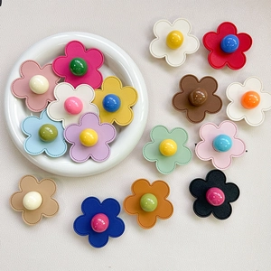 Flat lay of colorful floral phone grips with center beads and stitched petal details
