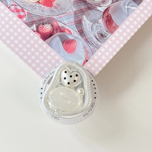 Detail of magnetic heart griptok with pearl gem and silver texture on strawberry box