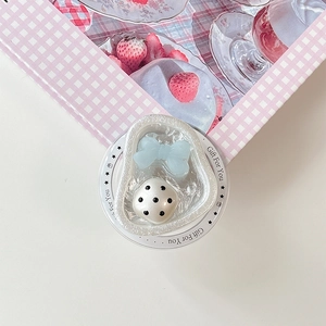 Detail of blue bow and white polka dot beads on magnetic phone grip stand