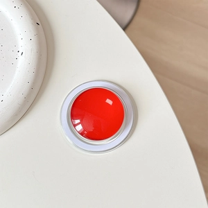 Top view of red crystal glass MagSafe phone grip with magnetic base on white surface