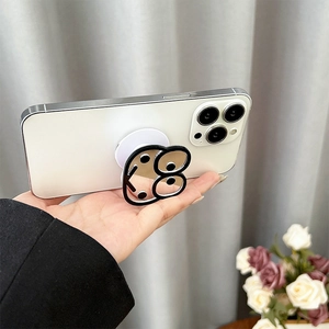 Silver mirror phone grip with cartoon eye design on an expandable airbag stand