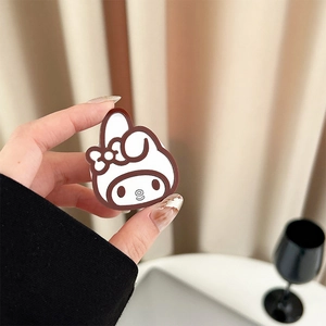 Detail of My Melody character phone grip holder held by hand for scale and size check