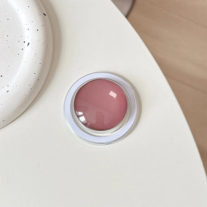 Macro shot of minimalist round crystal glass magnetic phone grip in elegant rose pink