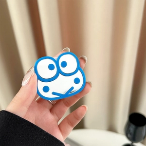Close-up of a blue and white cartoon frog phone stand held in hand with matte finish