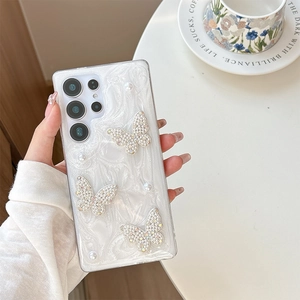 Detail of luxury Samsung S23 Ultra case with diamond butterfly and pearl texture