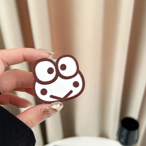 Detail of cute frog phone socket grip featuring classic cartoon character face design