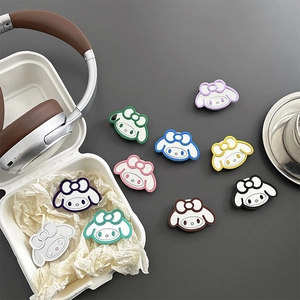 Colorful cartoon rabbit silicone phone socket grip collection on a grey desk