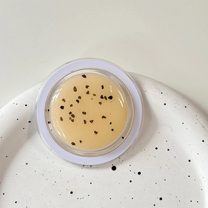 Macro shot of glittery MagSafe phone grip with smooth gel texture and fine black particles