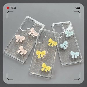 Transparent Samsung S25 Ultra case with glitter texture and 3D bows in pink, yellow and blue