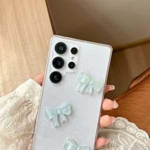 Detail of glitter transparent Samsung case with 3D blue bows and lens protection