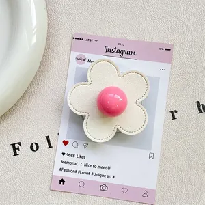 Detail of flower-shaped phone socket with white leather texture and pink glossy sphere