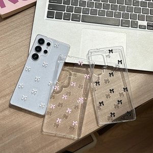 Glitter transparent Samsung Galaxy S25 case with 3D bowknot decor on wooden table