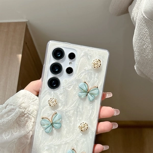 Detail of Samsung phone case with blue 3D butterflies and pearl texture held by hand