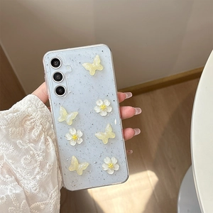 Detail of 3D yellow butterflies and white flowers on glittery light blue phone case