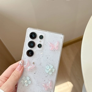 Close-up of glittery Samsung phone case with 3D pink butterflies and blue flowers