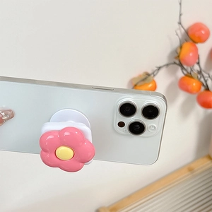 Detail of pink 3D flower phone socket with integrated mirror on a white smartphone