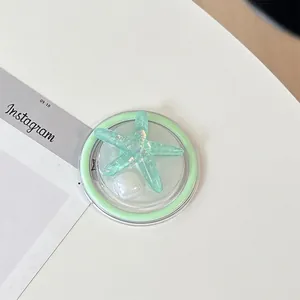 Macro detail of mint green starfish phone grip with glitter resin and magnetic base