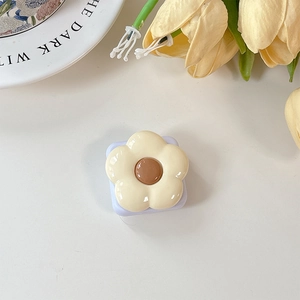 Detailed macro view of cream yellow flower phone grip with glossy resin finish