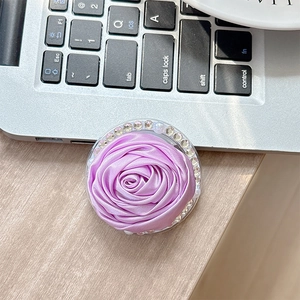 Close-up of purple camellia fabric phone socket with sparkling rhinestones and pearls