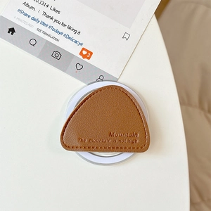 Detail of brown leather magnetic phone stand with Mountain engraving and stitching