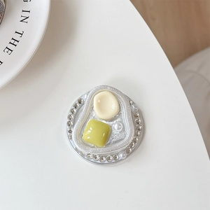 Detail shot of a round phone grip with crystal rhinestones, pearls and resin squares