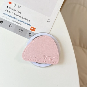 Detail of light pink leather phone grip with mountain engraving and lychee texture