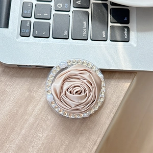 Detail of fabric camellia phone socket with champagne satin rose and rhinestones