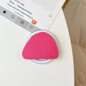Close-up of bright pink leather triangle magnetic phone grip with lychee grain texture