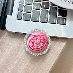 Detail of pink silk camellia phone grip with sparkling rhinestones and pearl accents