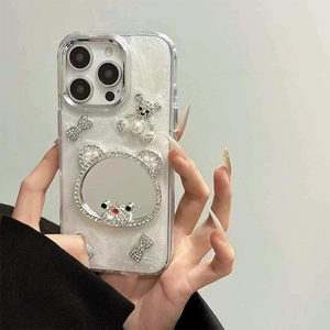 Detail of iPhone case with pearl finish, rhinestone bear, bow, and integrated mirror