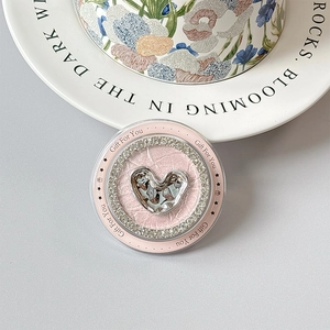 Macro view of pink rhinestone phone grip with silver heart and Gift For You text