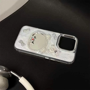 Detail of silver glitter phone case with bear-shaped mirror and rhinestone bows