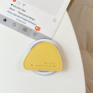 Detail of yellow triangle leather magnetic phone grip with embossed mountain quote