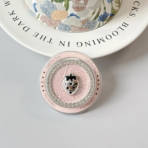 Detail of pink strawberry phone socket with rhinestones and Gift For You text