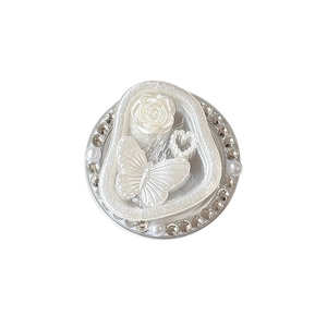 Elegant butterfly and rose phone grip with pearl and rhinestone accents on white background