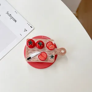 Detailed top view of tomato and mini cutting board phone grip on red base