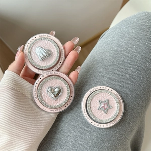 Pink leather phone sockets with rhinestone hearts and stars shown on a hand