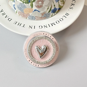 Detail of pink leather phone grip with silver metal heart and sparkling rhinestones