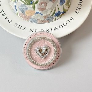 Macro detail of a pink magnetic phone socket with silver heart and Gift For You text