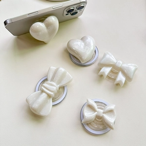 White pearlescent 3D bow and heart-shaped expanding phone grip stand set on mobile