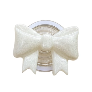 Pearly white glitter bow tie cell phone expansion stand with shiny textured surface