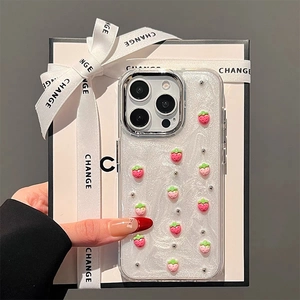 Close-up of 3D pink strawberry charms and silver beads on glittery iPhone phone case