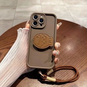 Close-up of leather fish-shaped phone case with a thick woven crossbody strap for iPhone