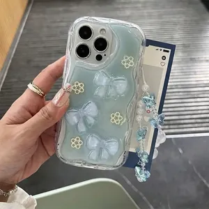 Mint green wave-edge phone case with 3D pearl flowers and a butterfly beaded charm