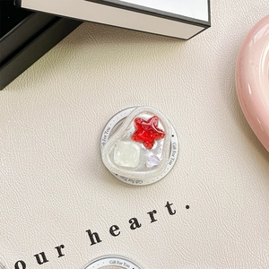Detail of seashell resin phone grip with starfish, gem and heart on gift card