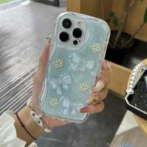 Mint green iPhone case with 3D pearl flowers, bows, and wave edges for protection