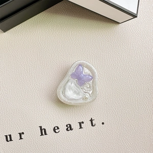 Detail of glitter purple butterfly phone grip with pearl and irregular resin surface